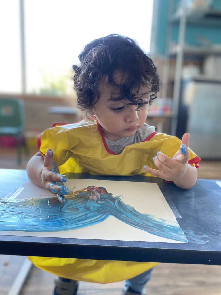 Young toddler finger painting
